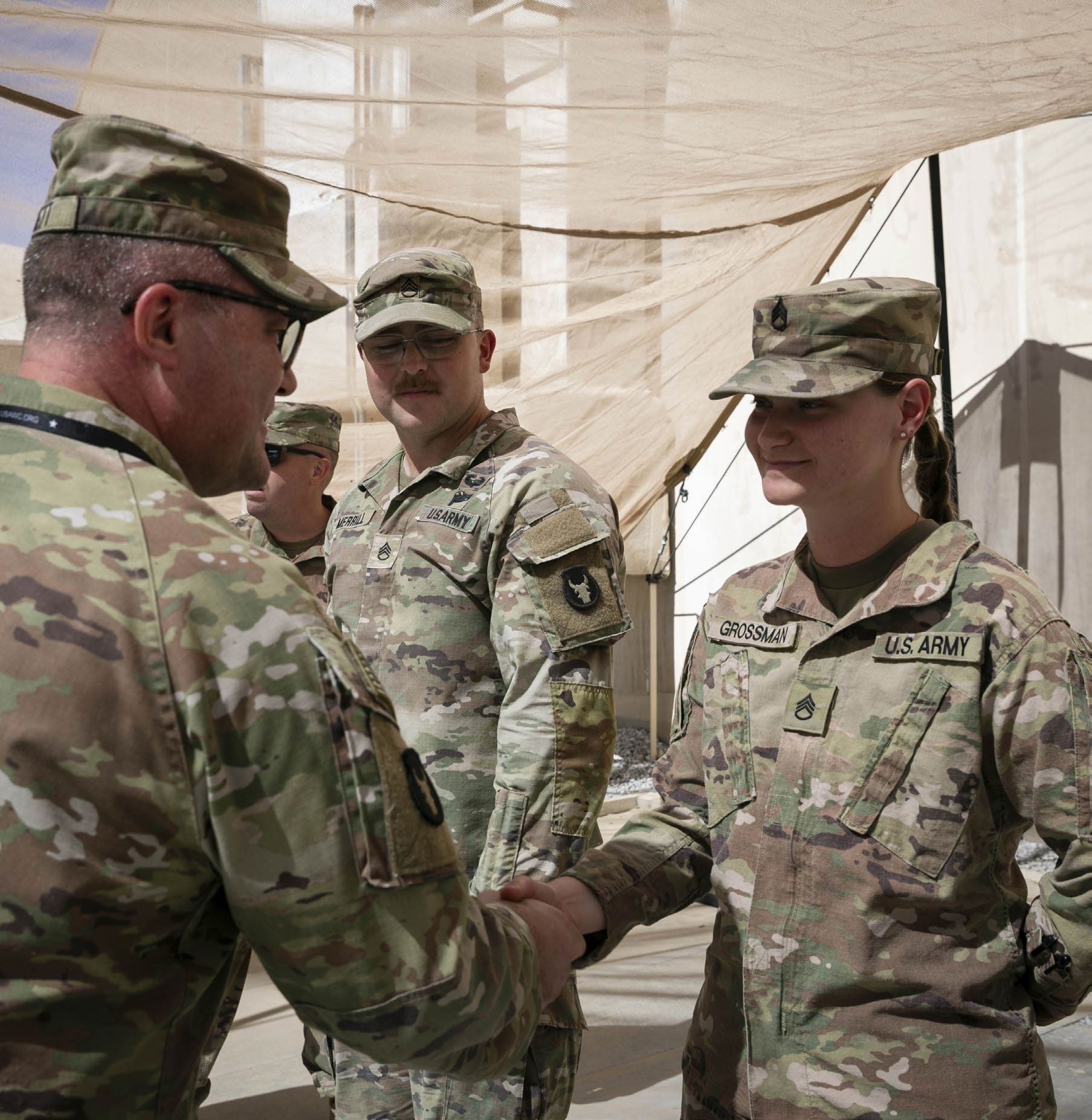 LTC Jay Hackett (left), commander for
            Headquarters and Headquarters Battalion,
            34th Infantry Division, Task Force Spartan,
            presents a coin to SSG Tayler Grossman
            (right), paralegal specialist assigned to
            Headquarters Support Company, during a
            Soldier and NCO of the Month recognition
            ceremony in the U.S. Central Command’s
            area of operations. (Credit: SSG Mahsima
            Alkamooneh)